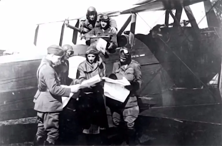 a-black-and-white-photo-of-raf-pilots-studying-maps-before-a-mission