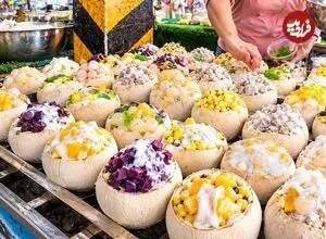 ببینید| غذای خیابانی در تایلند؛ تهیه یک غذای محبوب با نارگیل، برنج و دوریان در بانکوک