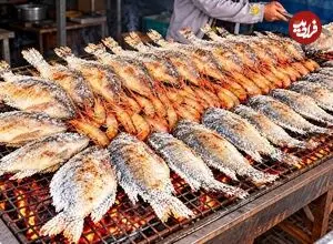 ببینید| غذای خیابانی در تایلند؛ مراحل دیدنی کباب کردن ماهی و میگو روی آتش در بانکوک