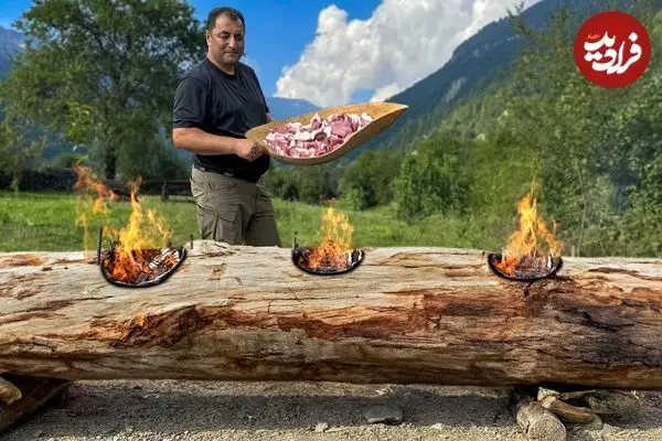 ببینید| غذای روستایی در آذربایجان؛ پخت مرغ، ماهی و گوشت روی تنه درخت