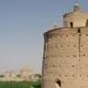 عکس| سفر زمان؛ زن روستایی در حال عبور از کنار یک «کبوترخانه»؛ سال 1340