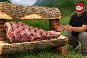 ببینید| غذای روستایی در آذربایجان؛ کباب کردن ران گاو با عسل و کره روی آتش