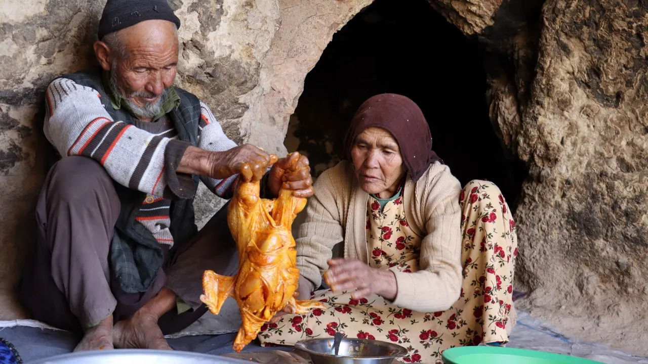 (ویدئو) فرآیند پخت یک غذای سنتی با مرغ و سیب زمینی توسط زوج غارنشین افغان