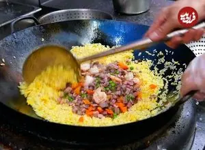 ببینید| غذای خیابانی در آمریکا؛ پخت یک غذای خاص با برنج، میگو، مرغ و بادام هندی در نیویورک