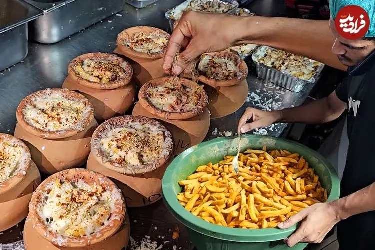 ببینید| غذای خیابانی در پاکستان؛ پخت یک غذای خاص با سیب زمینی و پنیر خامه ای در کوزه در کراچی